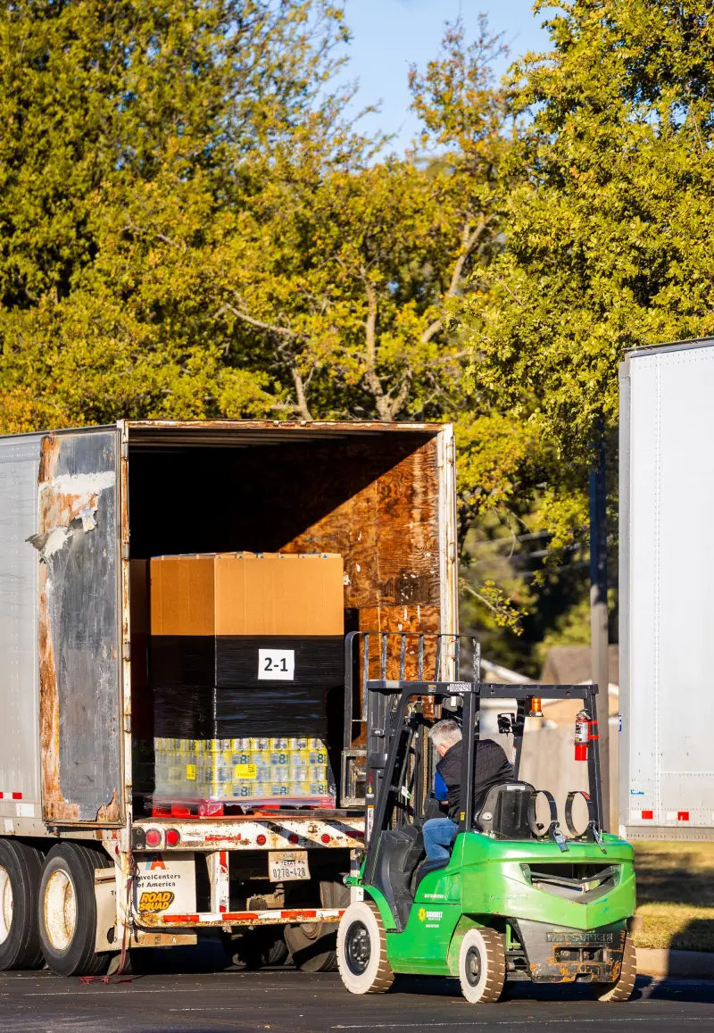 Forklift loading a pallet onto a truck