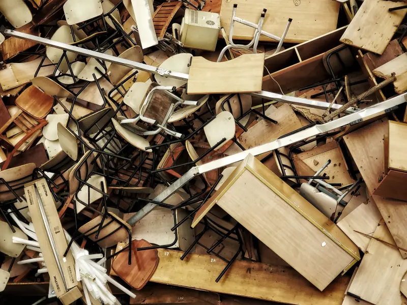 Pile of discarded wooden furniture and chairs