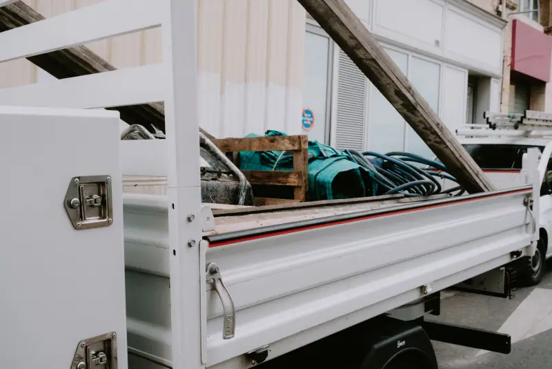 Truck bed loaded with equipment, hoses and a ladder rack